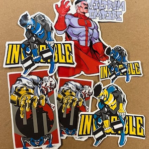 May include: A set of seven stickers featuring a superhero theme. The stickers feature a red, white and blue superhero with the text "Viltrum Empire". Other stickers feature a blue and yellow superhero lifting weights with the text "Invisible".