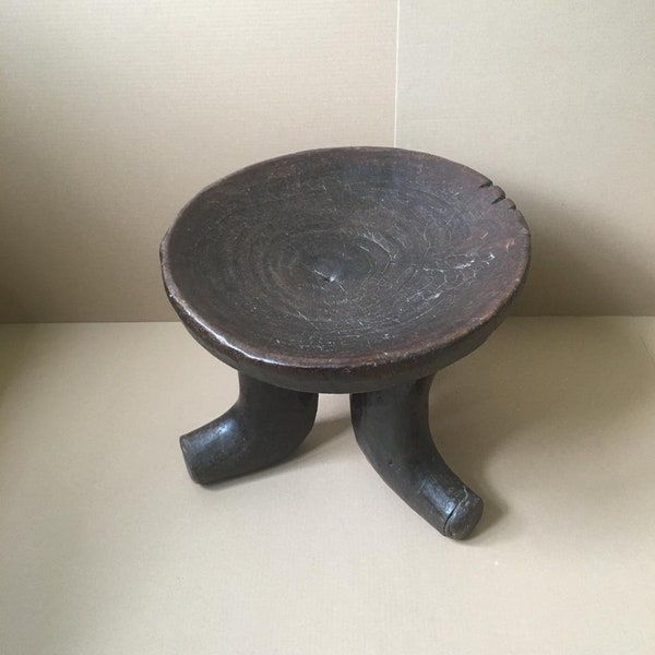 A well-maintained large Ethiopian (Oromo) shell stool on three sturdy legs, cut from a single trunk