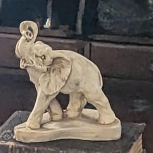 Vintage Resin Elephant with Carving. A Lovely Cream Color with Intricate detailing. A very nice addition for animal collectors or Elephants.