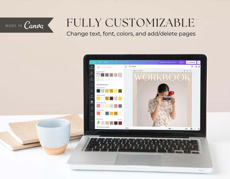 May include: A laptop computer displaying a Canva design template for a workbook. The template features a woman holding a camera and the word "WORKBOOK" in a bold, sans-serif font.