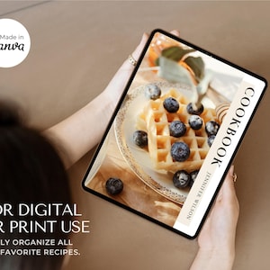 May include: A digital cookbook on a tablet, showing a waffle with blueberries. The tablet displays "COOKBOOK" and "JENNIFER WILSON". The image also includes the text "FOR DIGITAL OR PRINT USE" and "EASILY ORGANIZE ALL THE FAVORITE RECIPES."