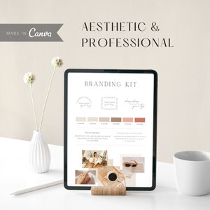 May include: Branding kit mockup on a tablet screen. The kit includes a logo template, color palette, and font choices. The colors are beige, brown, and pink. The fonts are Montserrat and Woodland Ultra Light. The text on the screen reads "Branding Kit", "Shop", "Your Logo", "Shop", "Your Logo", "Shop", "Your Logo", "Montserrat", "ABCDEFGHIJKLMNOPQRSTUVWXYZ", "abcdefghijklm", "1234567890", "Woodland Ultra Light", "ABCDEFGHIJKLMNOPQRSTUVWXYZ", "abcdefghijklm", "1234567890".