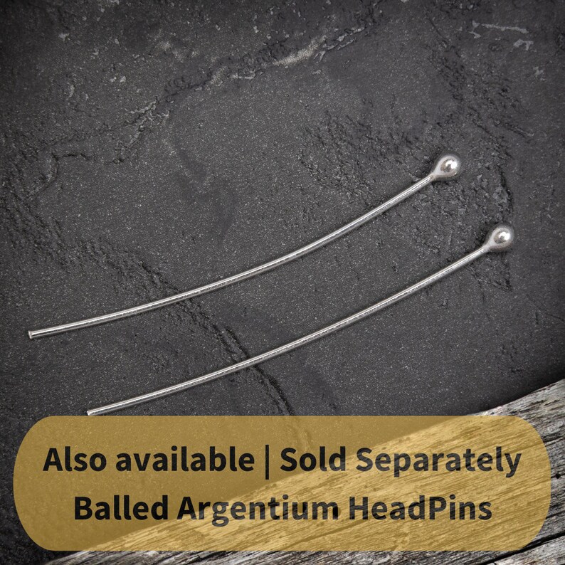 May include: Two silver ball-headed headpins on a dark gray textured surface. The text "Also available | Sold Separately Balled Argentium HeadPins" is on a gold background.