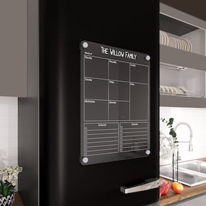 May include: A black dry-erase board with a white frame and the text "THE WILLOW FAMILY" at the top. The board is divided into sections for each day of the week, a to-do list, and groceries.