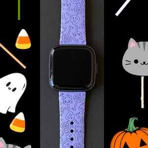 May include: A purple silicone watch band with a Halloween theme. The band features a repeating pattern of ghosts, pumpkins, candy corn, and cats.