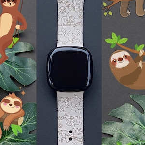 May include: White silicone watch band with a black watch face. The band has a repeating pattern of sloths in various poses, including hanging from branches, sleeping, and swinging on a swing. The band is designed for a smartwatch.