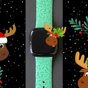 May include: A green silicone Apple Watch band with a Christmas moose pattern. The band has a black watch face with a moose illustration.