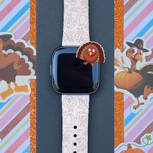 May include: White watch band with a Thanksgiving-themed design featuring turkeys, pumpkins, and leaves. The band is made of silicone and has a white background with brown and black details.