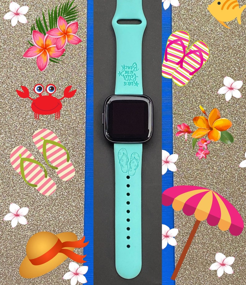 May include: A turquoise blue Apple Watch band with a white design of flip flops and the text "Life is better at the beach".