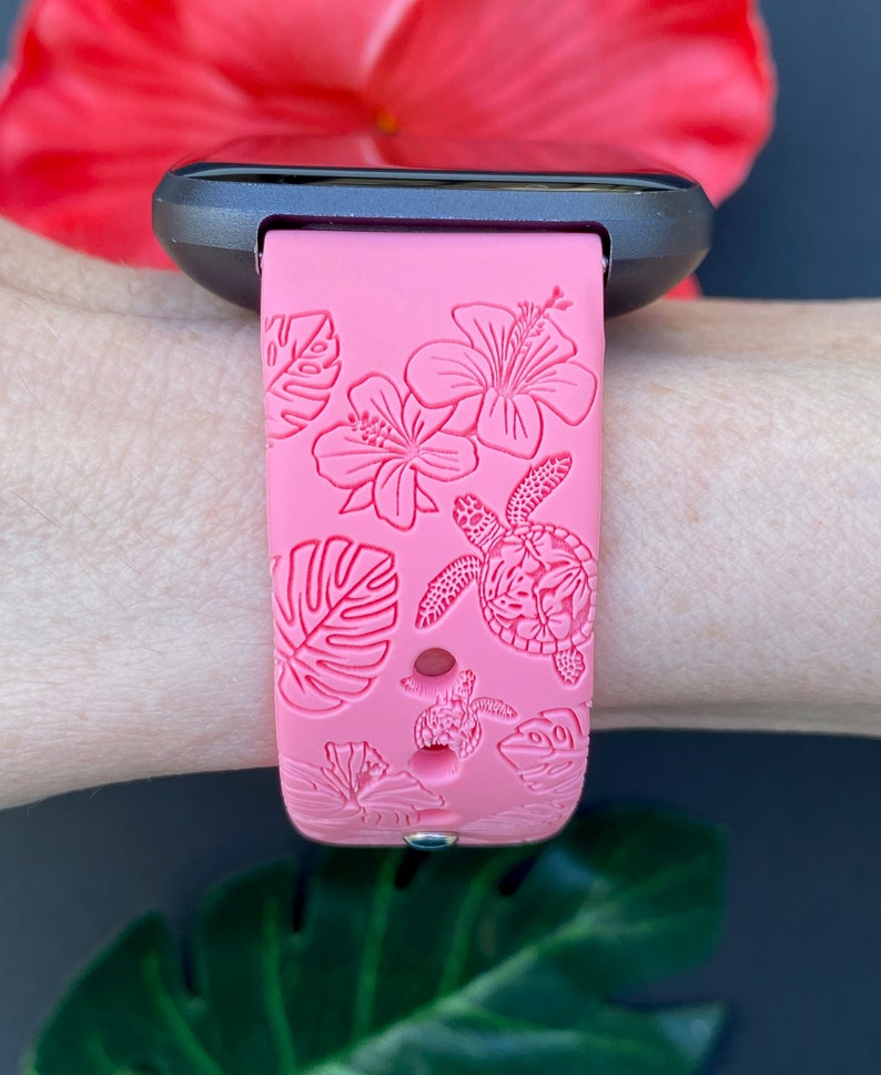 May include: Pink silicone watch band with a tropical floral and turtle design.