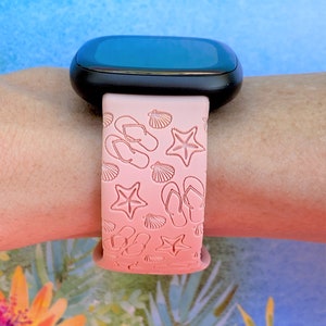 May include: A pink silicone watch band with a gradient design featuring flip flops, seashells, and starfish.