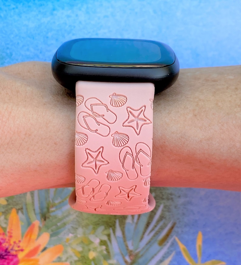 May include: A pink silicone watch band with a gradient design featuring flip flops, seashells, and starfish.