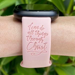 May include: A pink silicone watch band with the text "I can do all things through Christ" embossed on it.