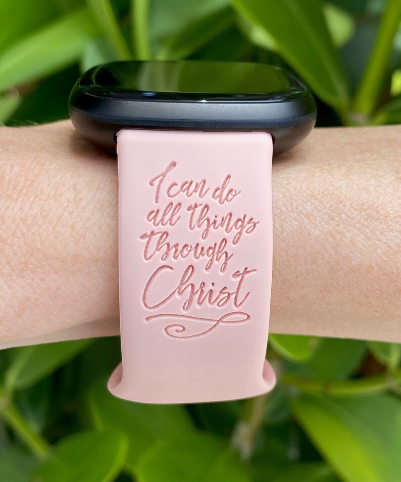 May include: A pink silicone watch band with the text "I can do all things through Christ" embossed on it.