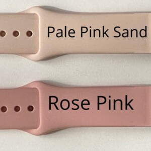 May include: Four Apple Watch bands in different colors: gray, pale pink sand, rose pink, and green. Each band has a buckle and four holes.