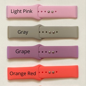 May include: Six different colored silicone watch bands with silver metal clasps. The bands are labeled "Sea Foam", "Light Pink", "Gray", "Grape", "Orange Red", and "Rose Pink".