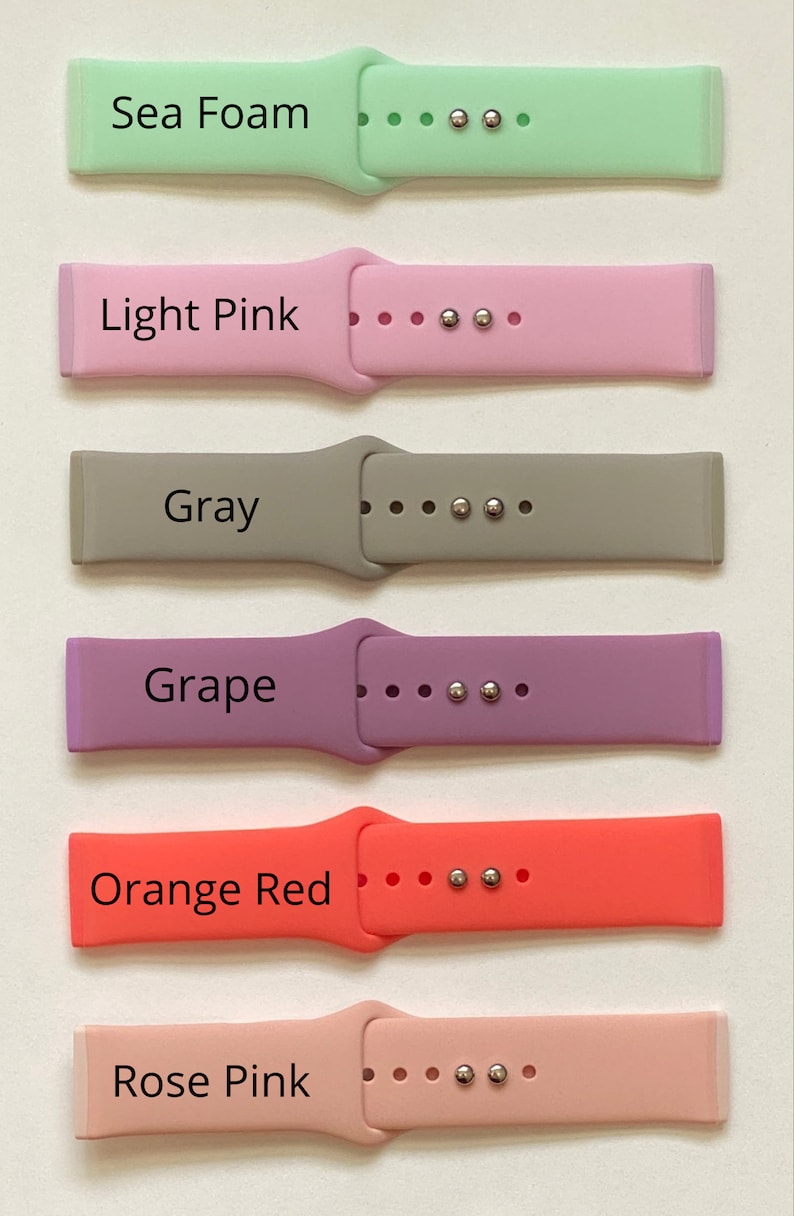 May include: Six different colored silicone watch bands with silver metal clasps. The bands are labeled "Sea Foam", "Light Pink", "Gray", "Grape", "Orange Red", and "Rose Pink".