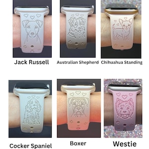 May include: A collection of light-colored watch bands with engraved dog portraits. The bands feature designs of a Jack Russell, Australian Shepherd, Chihuahua, Cocker Spaniel, Boxer, and Westie. Each band has a heart pattern.