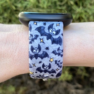 Puede incluir: Una correa de reloj gris y negra con un patr&oacute;n de murci&eacute;lagos y estrellas. La correa est&aacute; hecha de un material suave y flexible y es compatible con la mayor&iacute;a de los relojes inteligentes.