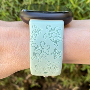 May include: A light green silicone watch band with a sea turtle and starfish design.