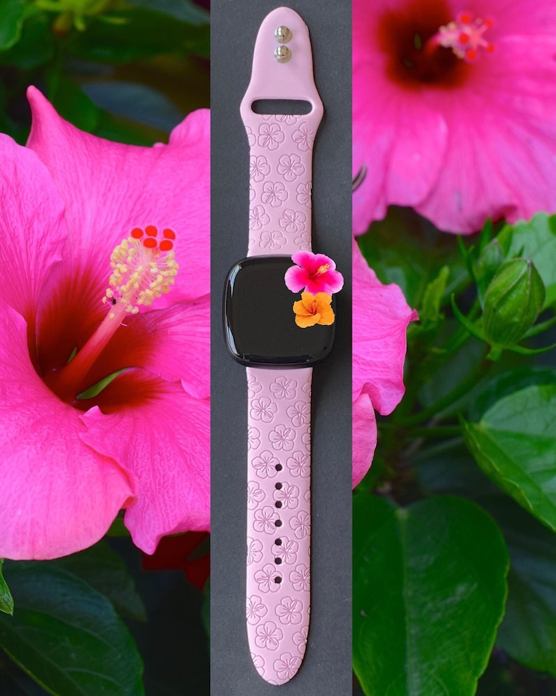 May include: A pink silicone watch strap with a floral pattern. The strap is designed for a smartwatch and has a black screen.
