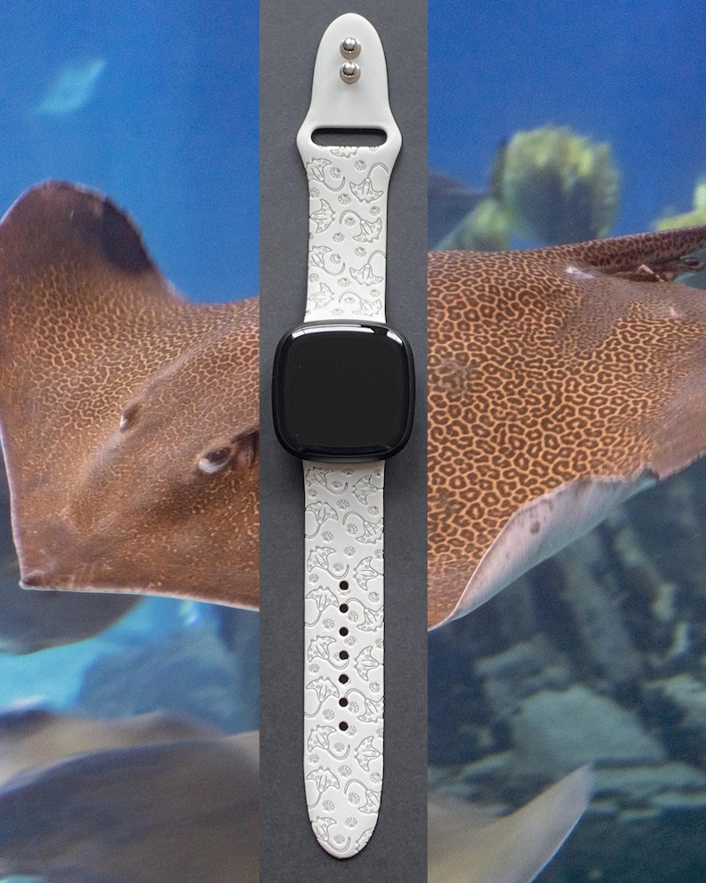 May include: White silicone Apple Watch band with a pattern of stingrays. The band is shown on a gray background.