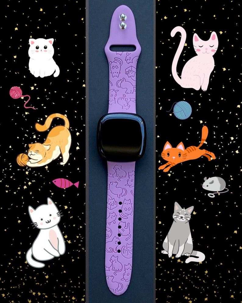 May include: A purple silicone watch band with a pattern of white cats. The band is designed for a smartwatch with a black face.