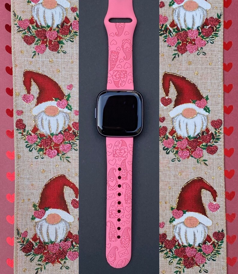 Peut inclure: Bracelet de montre en silicone rose sur le th&egrave;me de la Saint-Valentin. Le bracelet pr&eacute;sente un motif r&eacute;p&eacute;t&eacute; de gnomes, de c&oelig;urs et d'enveloppes.
