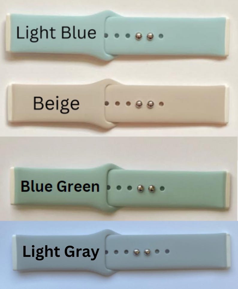May include: Four silicone watch bands in different colors: light blue, beige, blue green, and light gray. Each band has a white edge and silver metal accents.