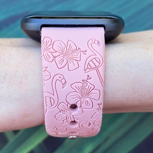 May include: A pink silicone watch strap with a tropical print featuring pink flamingos and hibiscus flowers.