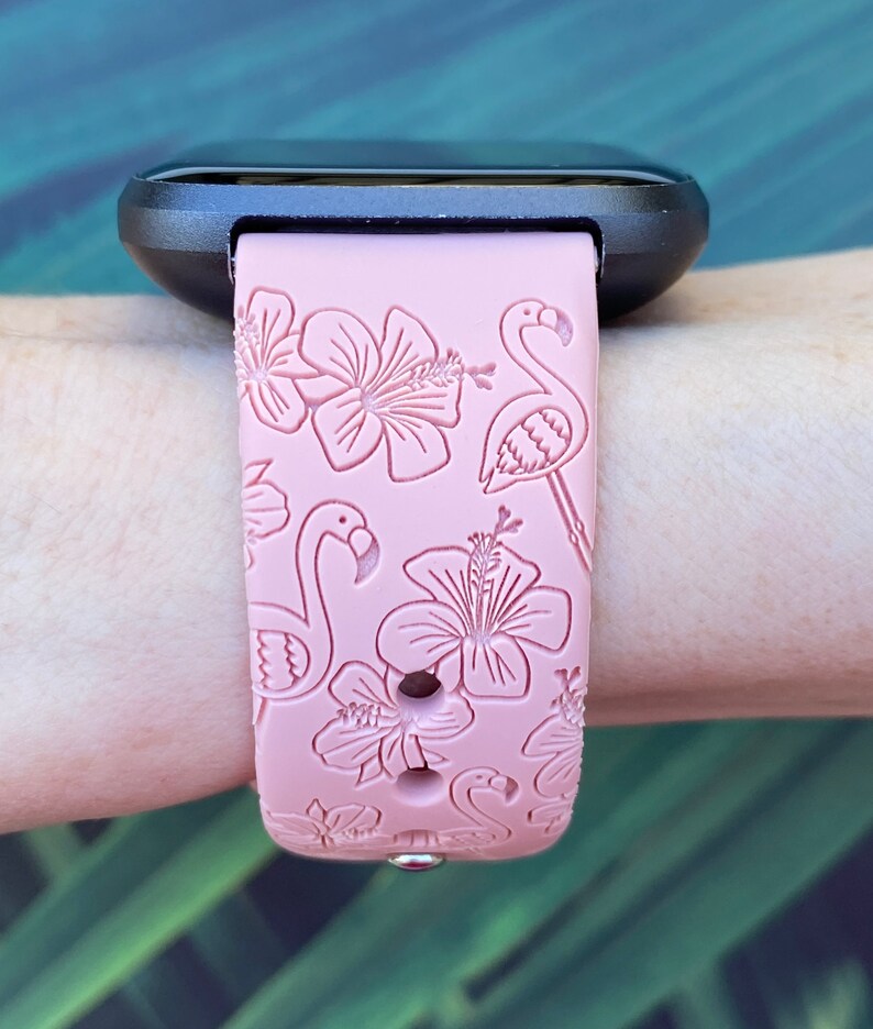 May include: A pink silicone watch strap with a tropical print featuring pink flamingos and hibiscus flowers.
