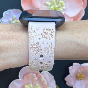 May include: A pink silicone watch band with a floral design and the text "best mom ever", "first my mother forever my friend", and "love you mom".