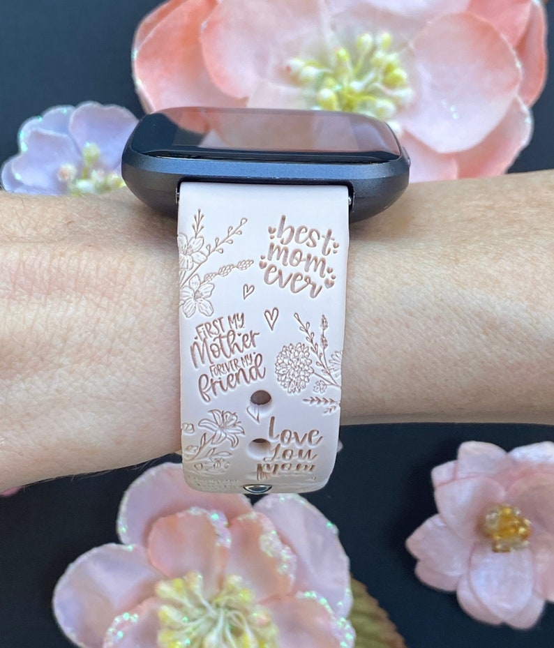 May include: A pink silicone watch band with a floral design and the text "best mom ever", "first my mother forever my friend", and "love you mom".