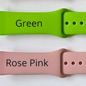 May include: Four silicone watch bands in different colours: orange, green, rose pink, and teal. Each band has three holes for adjusting the fit.