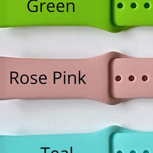 May include: Three Apple Watch bands in green, rose pink, and teal. The bands are made of silicone and have a buckle closure.