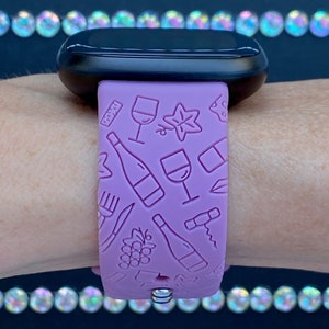May include: A purple silicone watch band with a wine-themed design. The band features embossed images of wine bottles, glasses, grapes, and corkscrews.