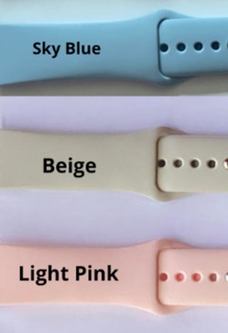 May include: Three silicone watch bands in sky blue, beige, and light pink. The bands are designed for smartwatches and have a buckle closure.