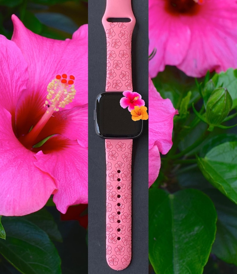 May include: Pink silicone watch band with a floral pattern. The band is shown against a background of pink hibiscus flowers.