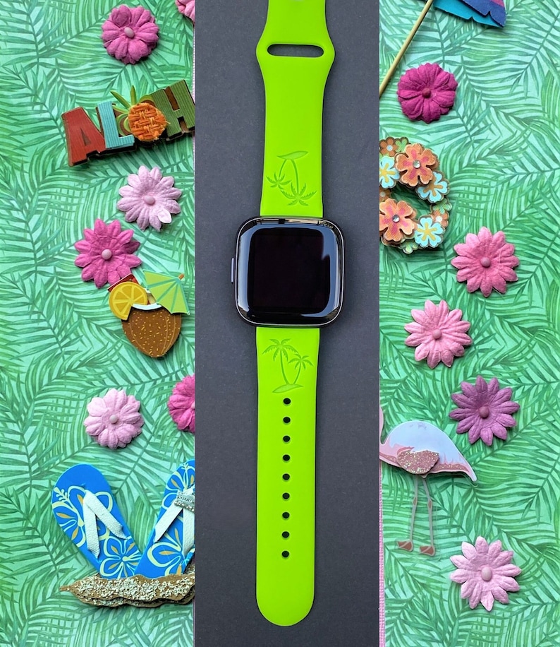 May include: A bright green silicone watch band with palm tree designs. The band is compatible with smartwatches.