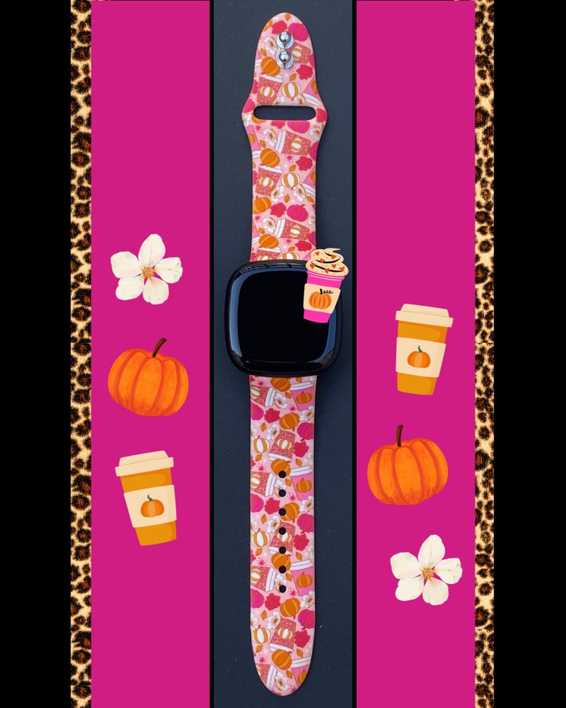 May include: A pink and orange Apple Watch band with a fall-themed design featuring pumpkins, coffee cups, and leaves. The band is shown on a black background with a pink and leopard print border.