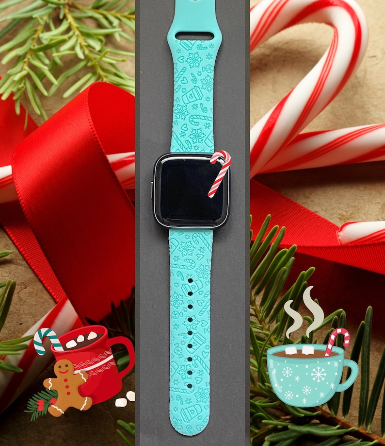 May include: A turquoise blue smartwatch band with a white Christmas-themed pattern. The band features snowflakes, candy canes, coffee cups, and hearts. The watch face is black and the band is on a grey background.