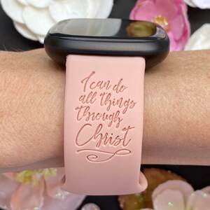 May include: A pink silicone watch band with the text "I can do all things through Christ" in a cursive font.
