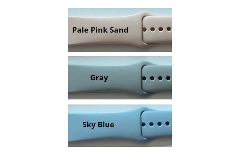 May include: Three different colored watch bands. The bands are made of a soft, flexible material. The colors are pale pink sand, gray, and sky blue.