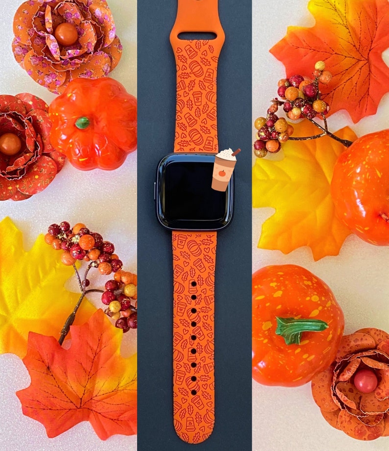 May include: Orange Apple Watch band with a fall-themed design featuring pumpkins, leaves, and coffee cups. The band is made of silicone and has a black background.