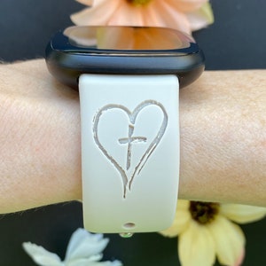 May include: White silicone watch band with a heart and cross design.