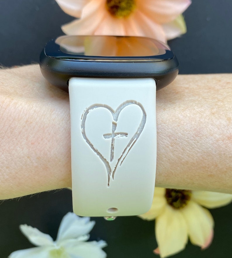 May include: White silicone watch band with a heart and cross design.