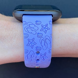 May include: A purple silicone watch band with a beach-themed design featuring flip flops, seashells, and starfish.