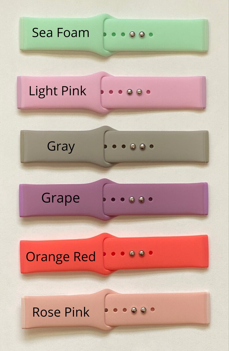 May include: Six different coloured silicone watch straps with silver metal clasps. The straps are labelled "Sea Foam", "Light Pink", "Gray", "Grape", "Orange Red", and "Rose Pink".