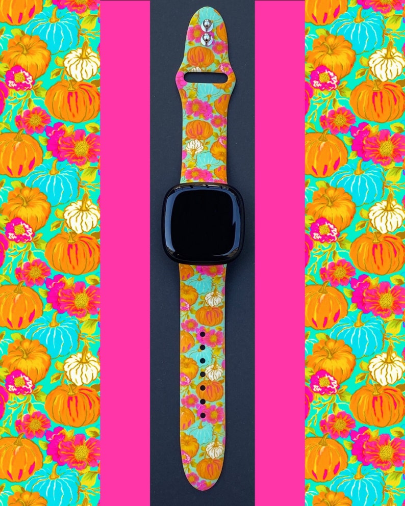 May include: A watch band with a colorful pumpkin and floral pattern. The band is made of silicone and has a black watch face.