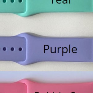 May include: Three Apple Watch bands in teal, purple, and bubble gum pink. Each band has a buckle closure and four holes for adjusting the fit.
